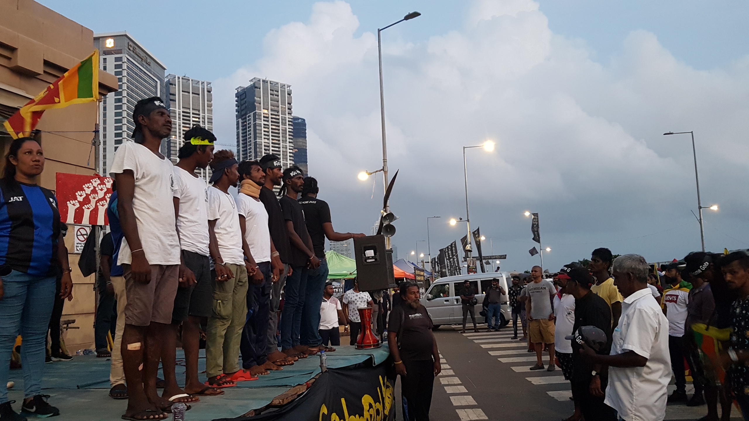 Protestors injured in the May 9th attack return to Galle Face, and stand on the stage at the barricade. Image credit: Amalini De Sayrah